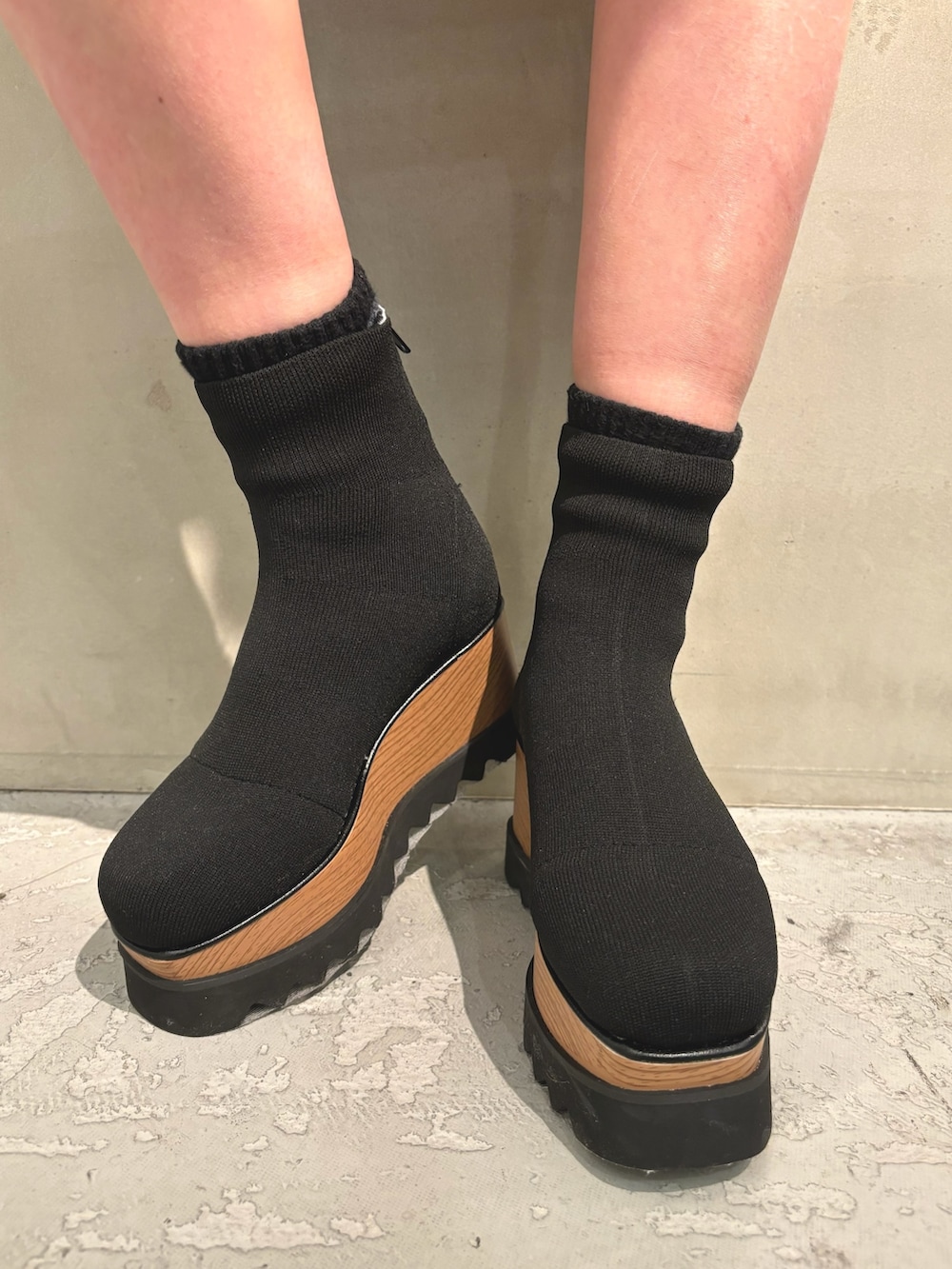 ホワイト系のブルゾン、ホワイト系のハンドバッグ、ブラック系のブーツを着用したレディースの冬コーディネートの7枚目の写真