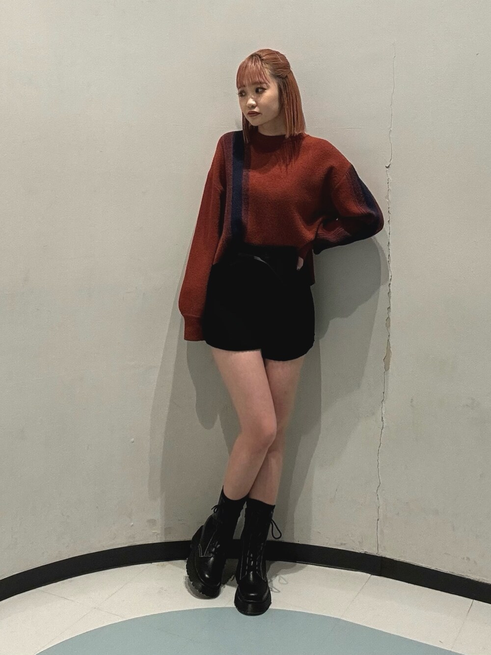 ブラック系のその他パンツ、オレンジ系のニット/セーター、グレー系のブルゾンを着用したレディースの冬コーディネートの4枚目の写真