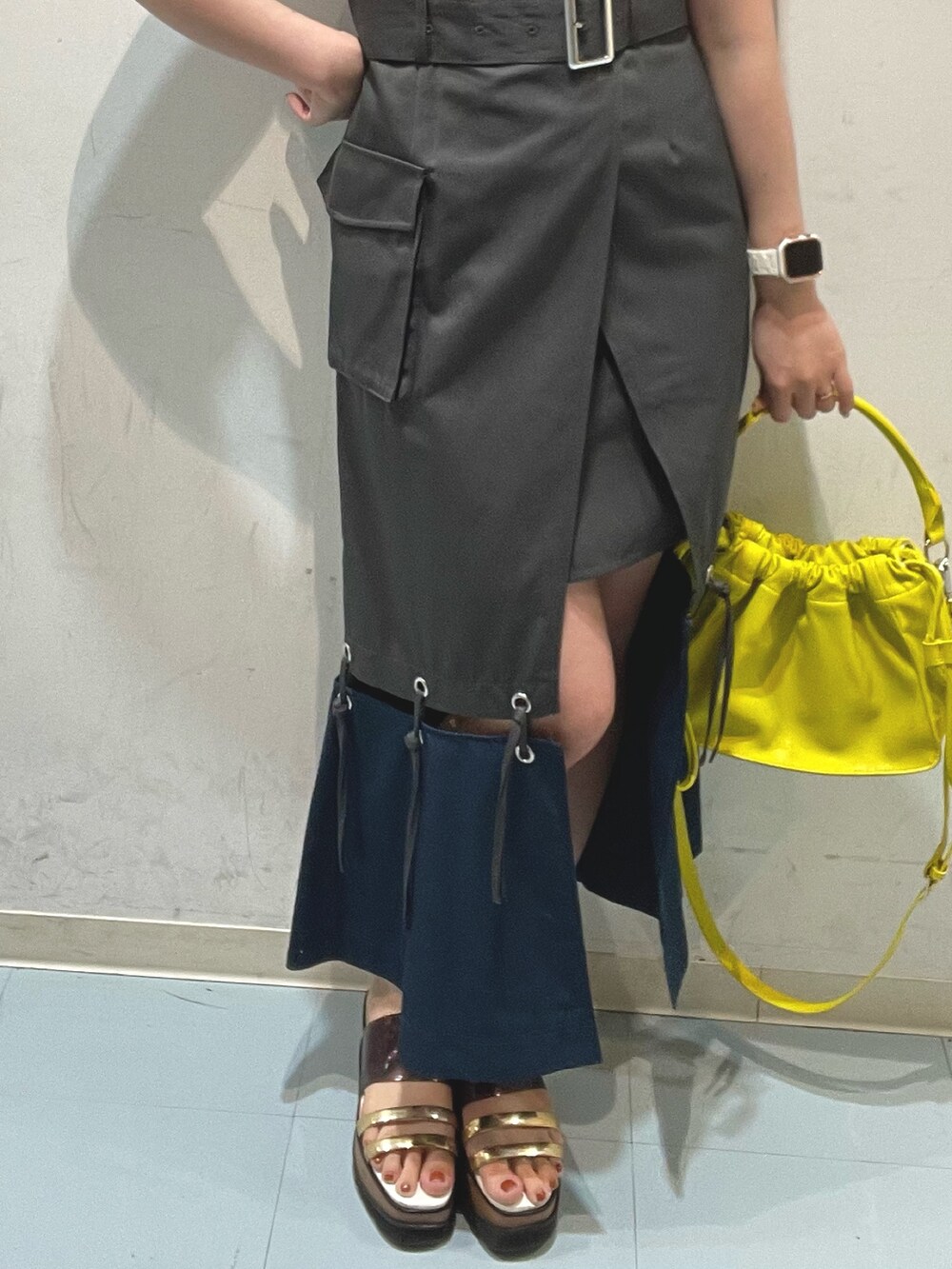 グレー系のワンピース、ブラック系のタンクトップ、イエロー系のハンドバッグを着用したレディースの夏コーディネートの5枚目の写真