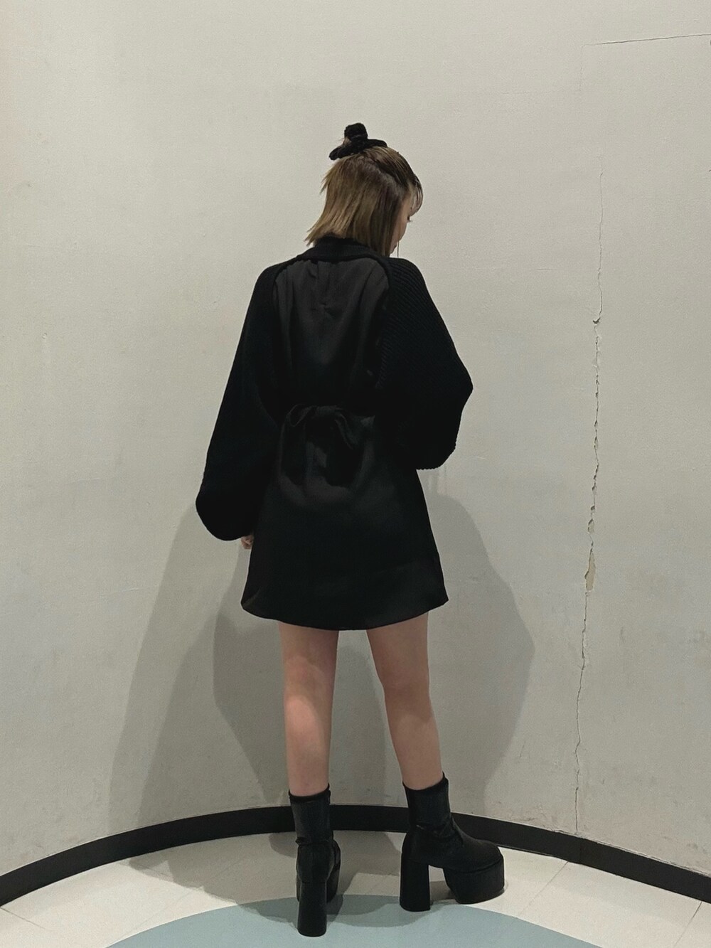 ホワイト系のハンドバッグ、ブラック系のワンピース、グリーン系のチェスターコートを着用したレディースの冬コーディネートの5枚目の写真