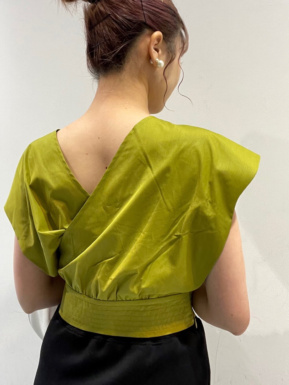 イエロー系のシャツ/ブラウス、ホワイト系のハンドバッグ、ブラック系のサンダルを着用したレディースの春コーディネートの4枚目の写真