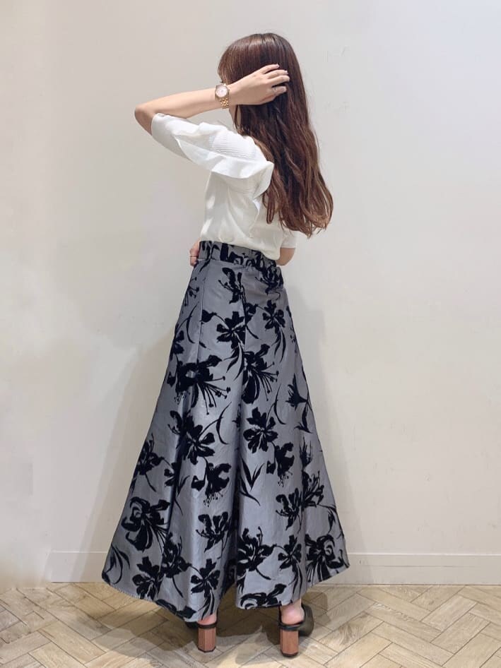 グレー系のスカート、ブラック系のサンダル、ホワイト系のニット/セーターを着用したレディースの夏コーディネートの7枚目の写真