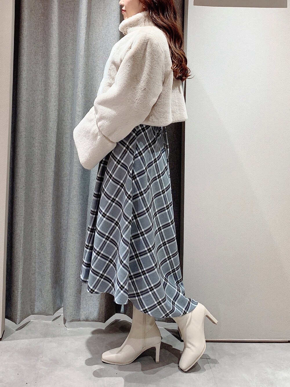 ホワイト系のワンピース、ホワイト系のブーツ、ベージュ系のその他アウターを着用したレディースの秋コーディネートの6枚目の写真