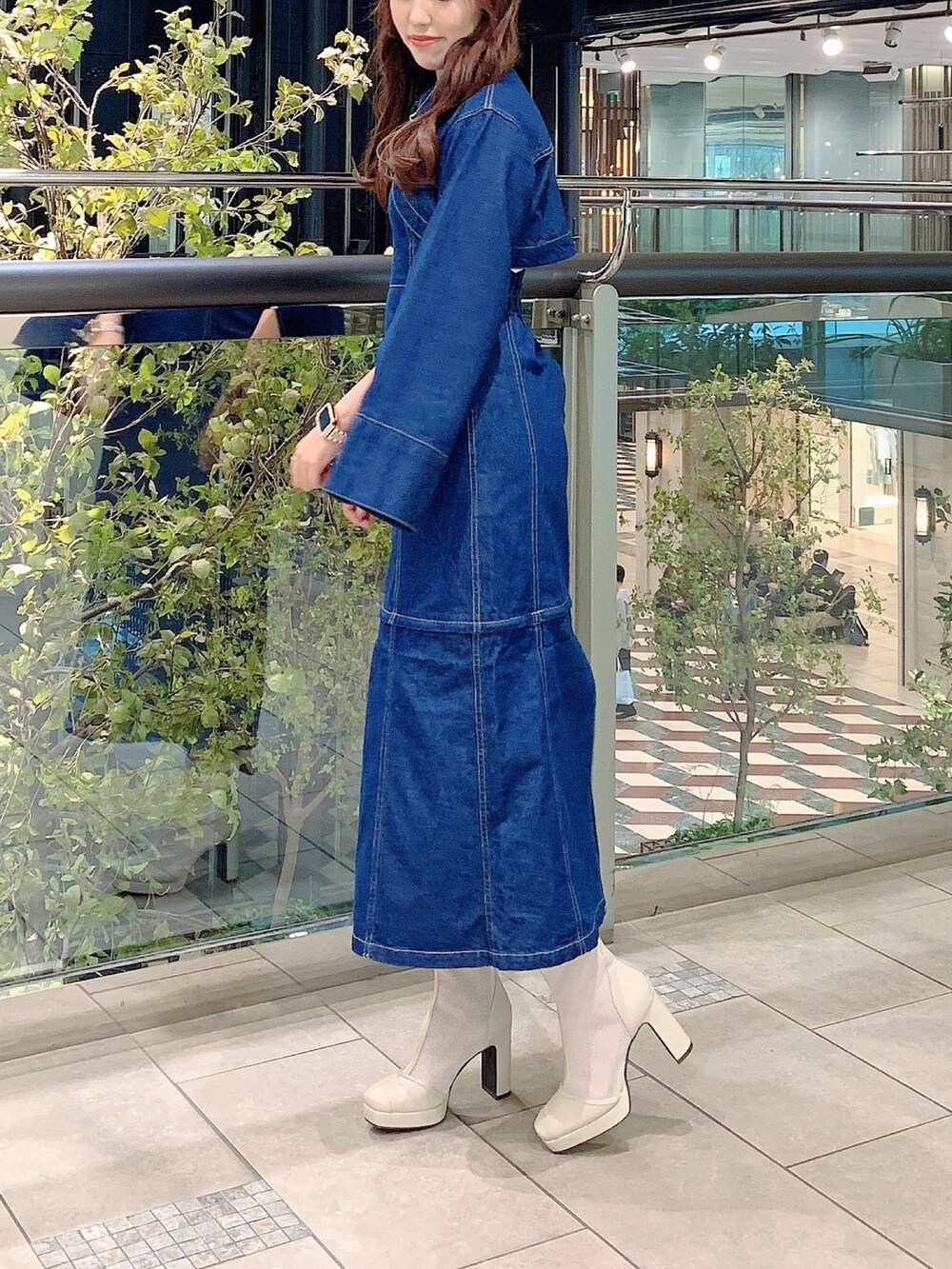 ホワイト系のブーツ、ブルー系のワンピースを着用したレディースの冬コーディネートの5枚目の写真