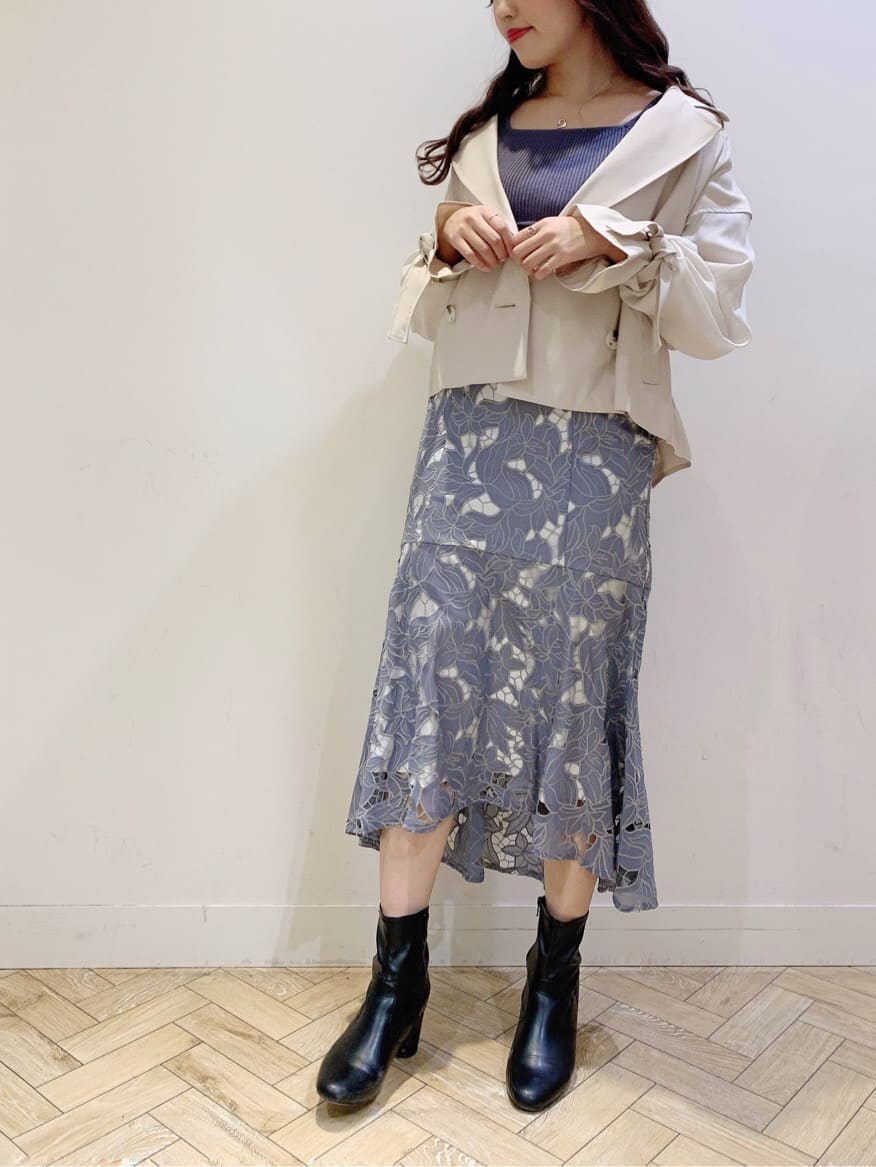 ベージュ系のトレンチコート、ブルー系のワンピースを着用したレディースの春コーディネートの4枚目の写真