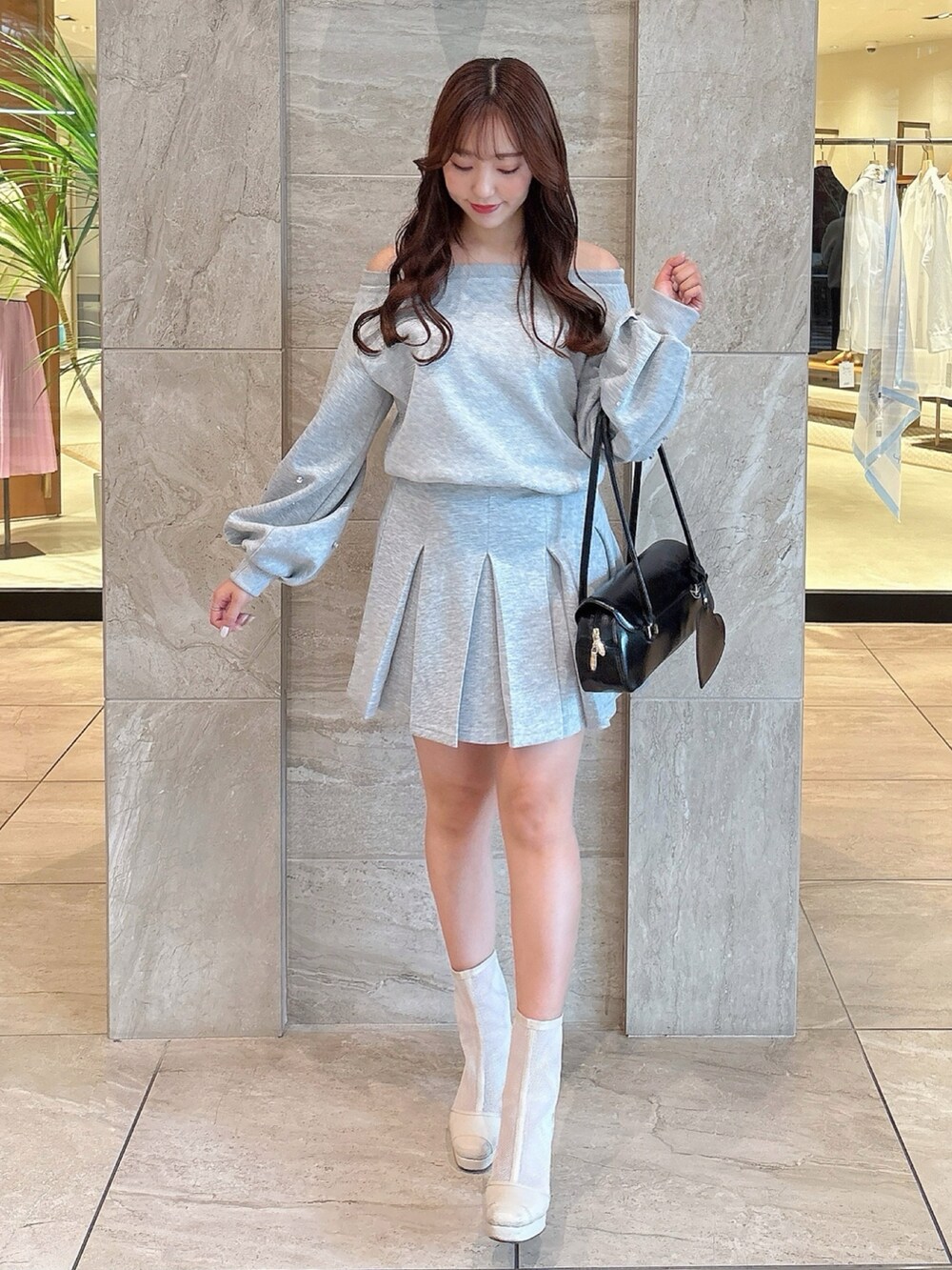 ホワイト系のブーツ、グレー系のスカート、グレー系のスウェットを着用したレディースの春コーディネートの6枚目の写真