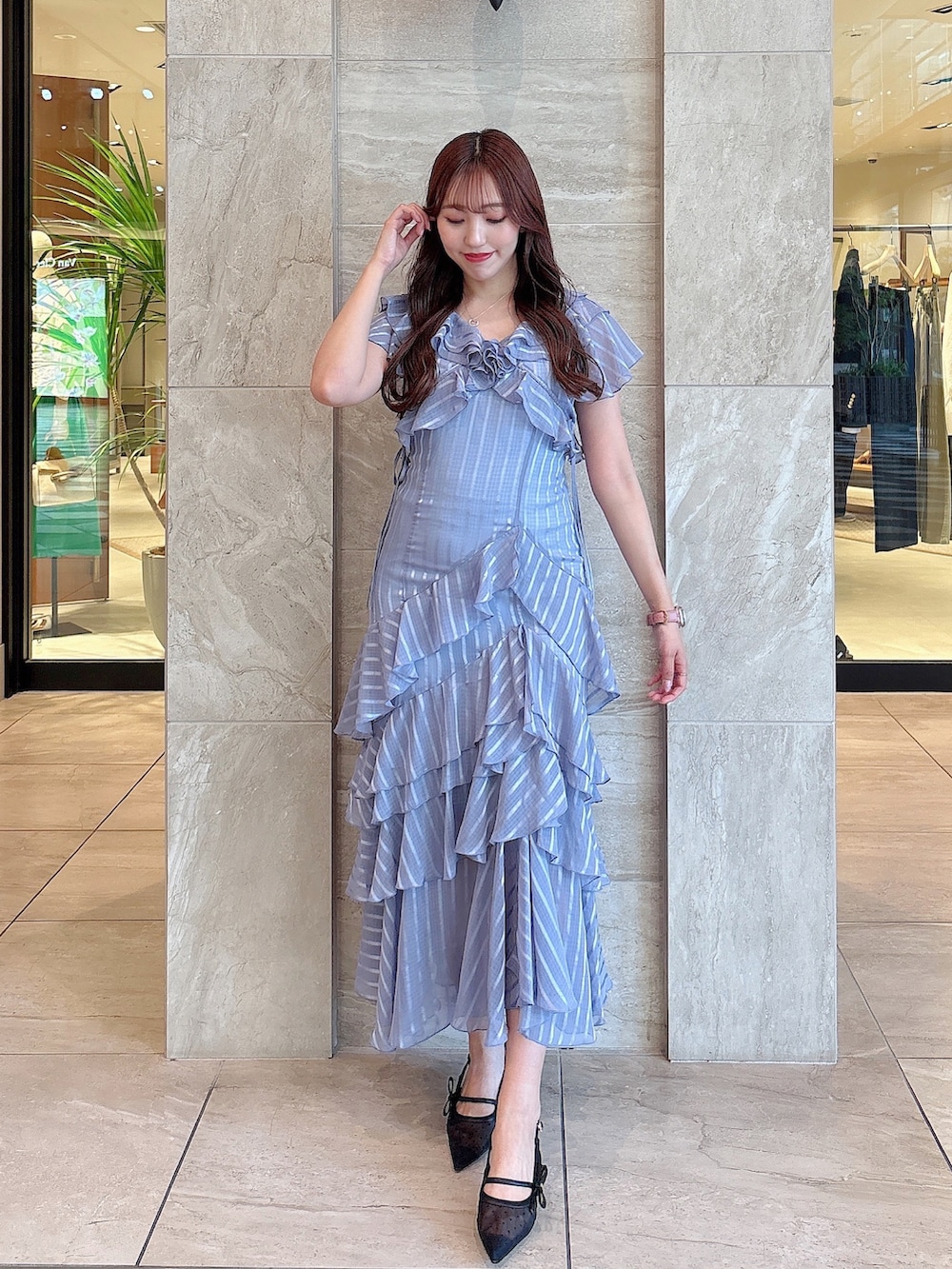 ブルー系のワンピース、ブラック系のパンプスを着用したレディースの春コーディネートの2枚目の写真