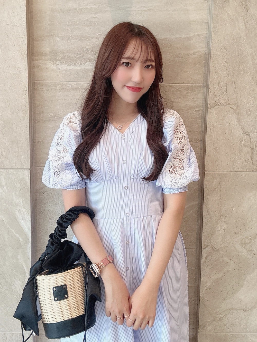 ブラック系のかごバッグ、ホワイト系のサンダル、ブルー系のワンピースを着用したレディースの夏コーディネートの7枚目の写真