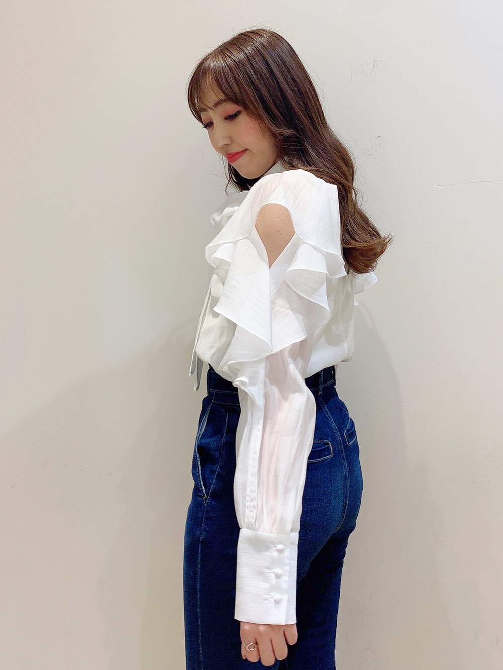 ホワイト系のシャツ/ブラウス、ブルー系のデニムパンツ、ホワイト系のハンドバッグを着用したレディースの冬コーディネートの8枚目の写真