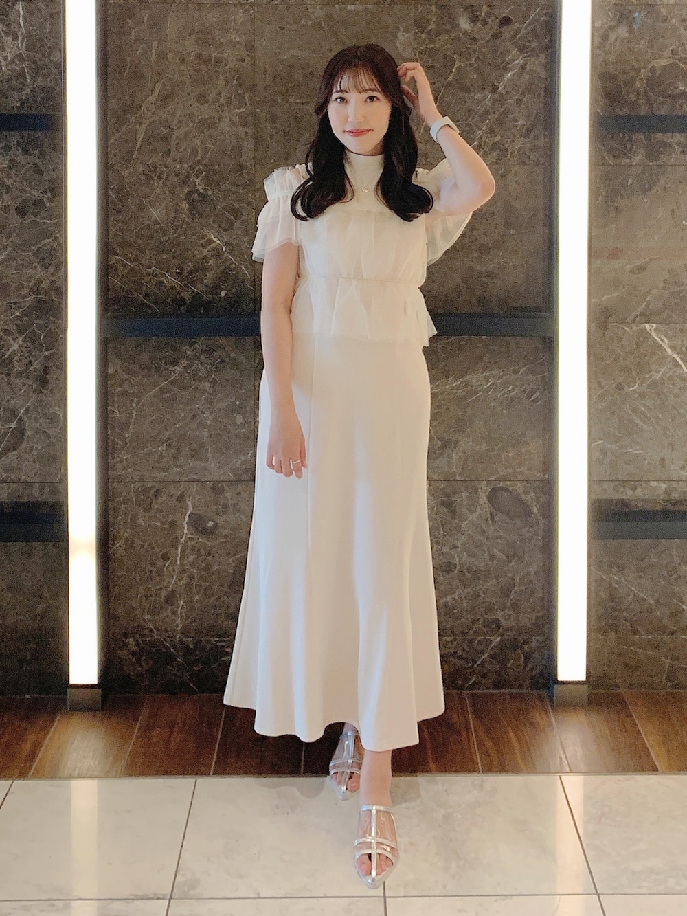 ホワイト系のワンピース、シルバー系のパンプスを着用したレディースの夏コーディネートの3枚目の写真