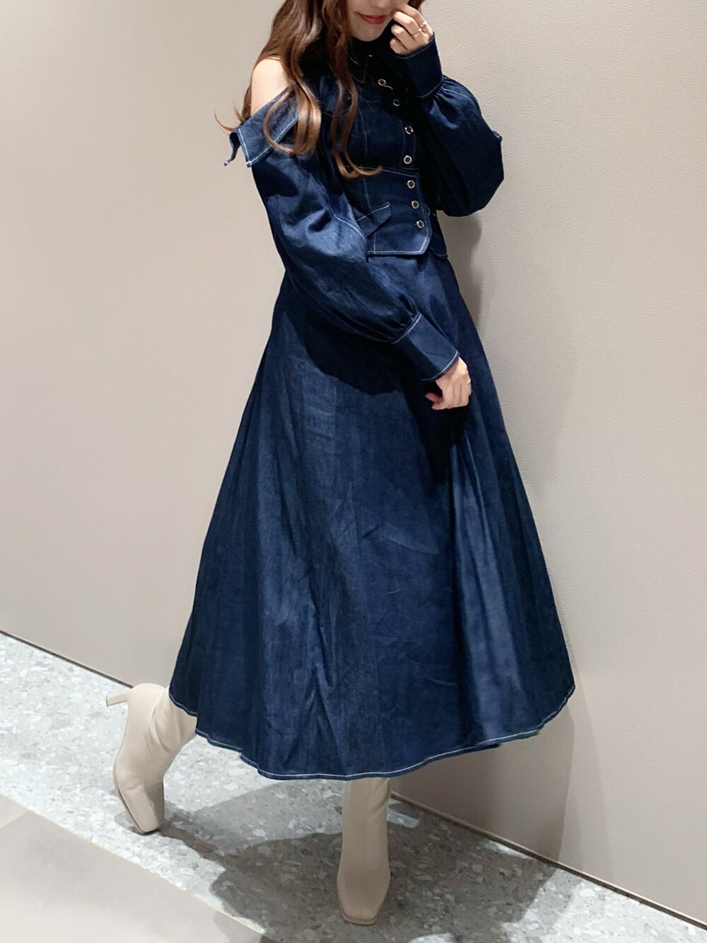 ホワイト系のブーツ、ブルー系のワンピースを着用したレディースの秋コーディネートの2枚目の写真