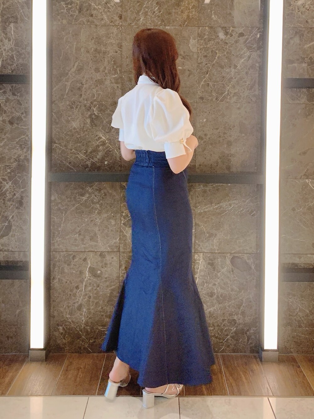 シルバー系のパンプス、ブルー系のスカート、ホワイト系のシャツ/ブラウスを着用したレディースの夏コーディネートの6枚目の写真