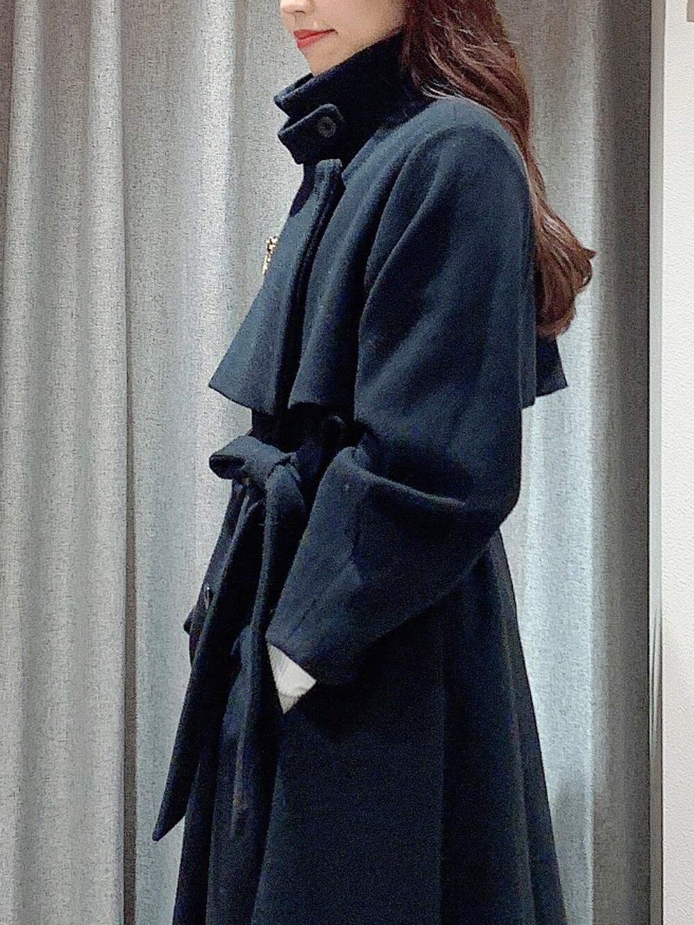 ホワイト系のワンピース、ホワイト系のブーツ、ブラック系のその他アウターを着用したレディースの冬コーディネートの9枚目の写真