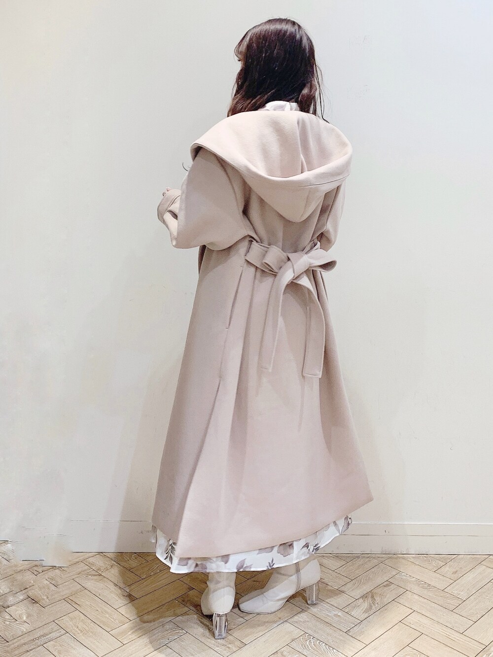 ベージュ系のチェスターコート、ホワイト系のワンピース、ホワイト系のブーツを着用したレディースの冬コーディネートの5枚目の写真