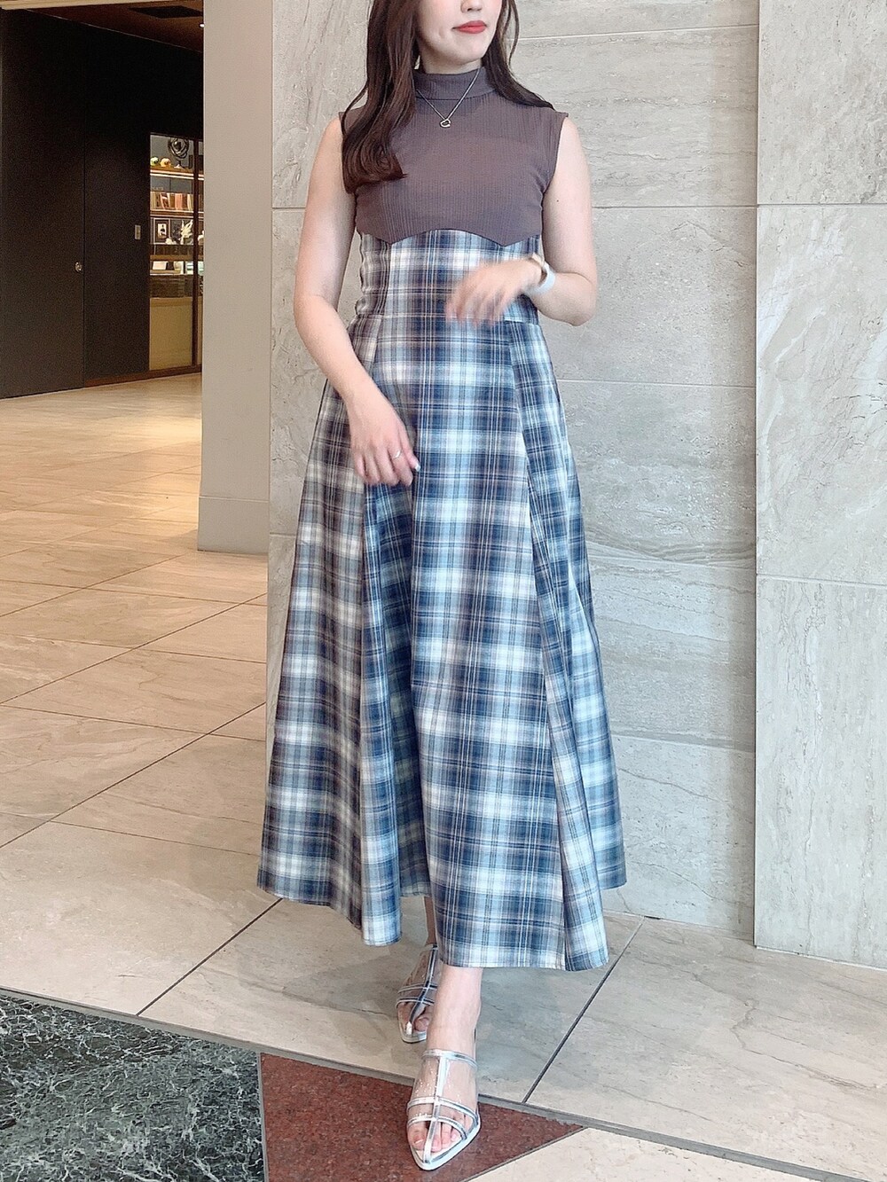 シルバー系のパンプス、ベージュ系のワンピースを着用したレディースの夏コーディネートの3枚目の写真