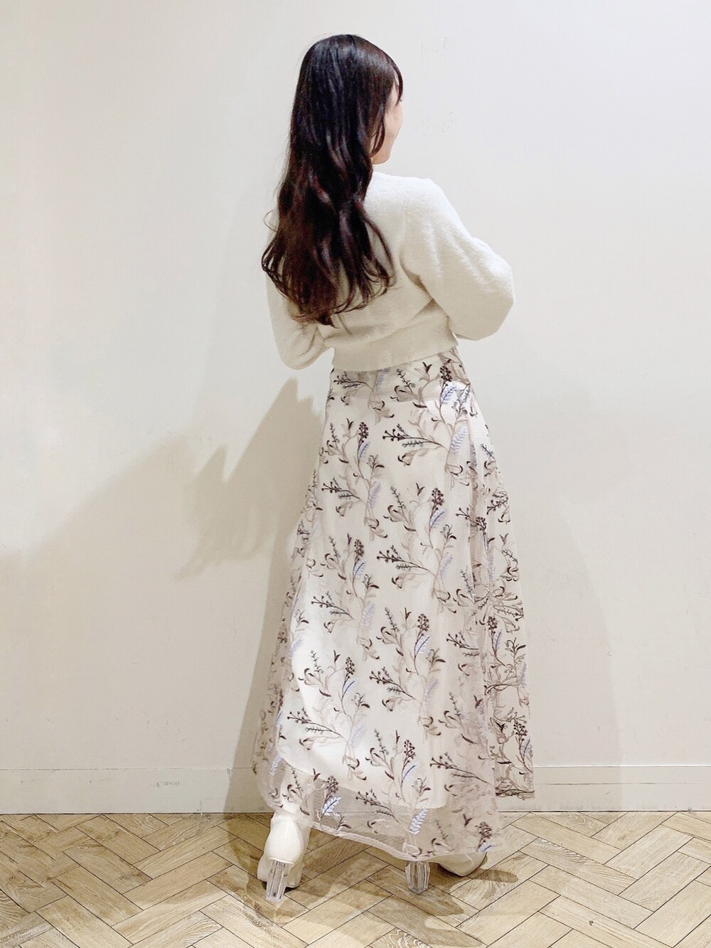 ピンク系のスカート、ホワイト系のカーディガン/ボレロ、ホワイト系のブーツを着用したレディースの秋コーディネートの5枚目の写真