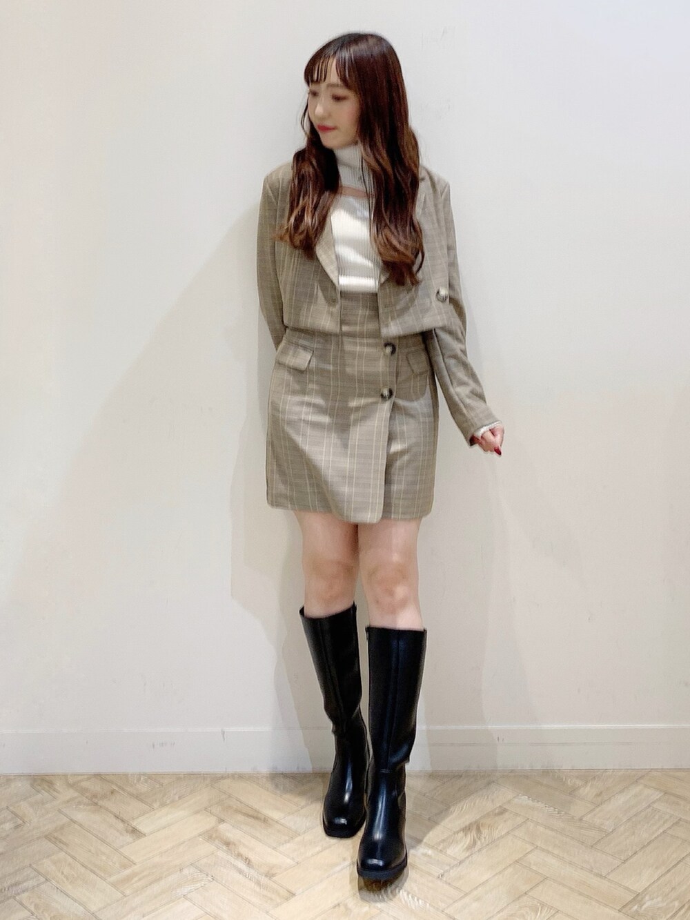 ホワイト系のニット/セーター、ブラック系のブーツ、ベージュ系のテーラードジャケットを着用したレディースの秋コーディネートの3枚目の写真