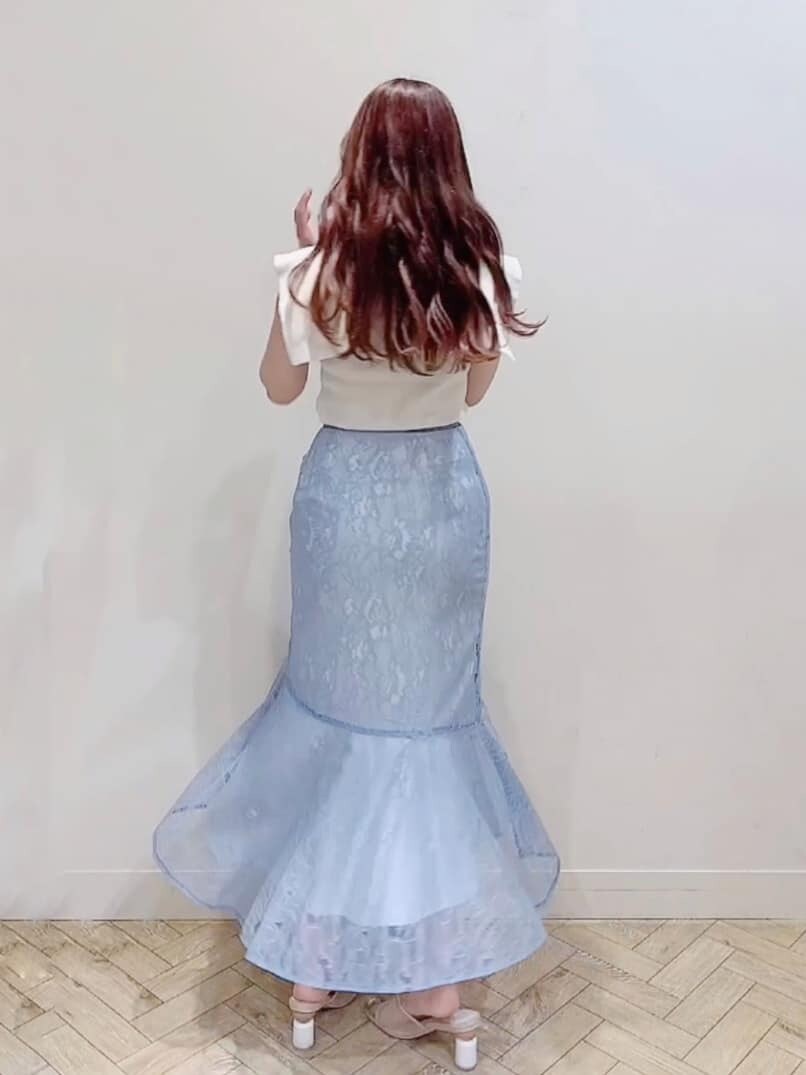 ブルー系のスカート、ホワイト系のニット/セーター、ベージュ系のサンダルを着用したレディースの夏コーディネートの4枚目の写真