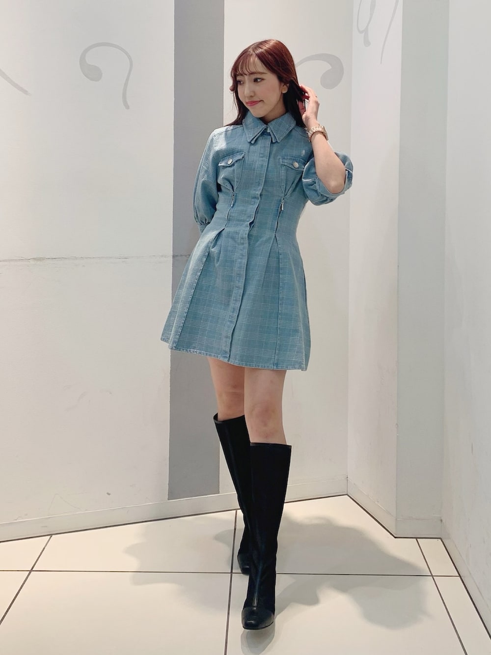 ブルー系のシャツワンピース、ブラック系のブーツを着用したレディースの冬コーディネートの4枚目の写真