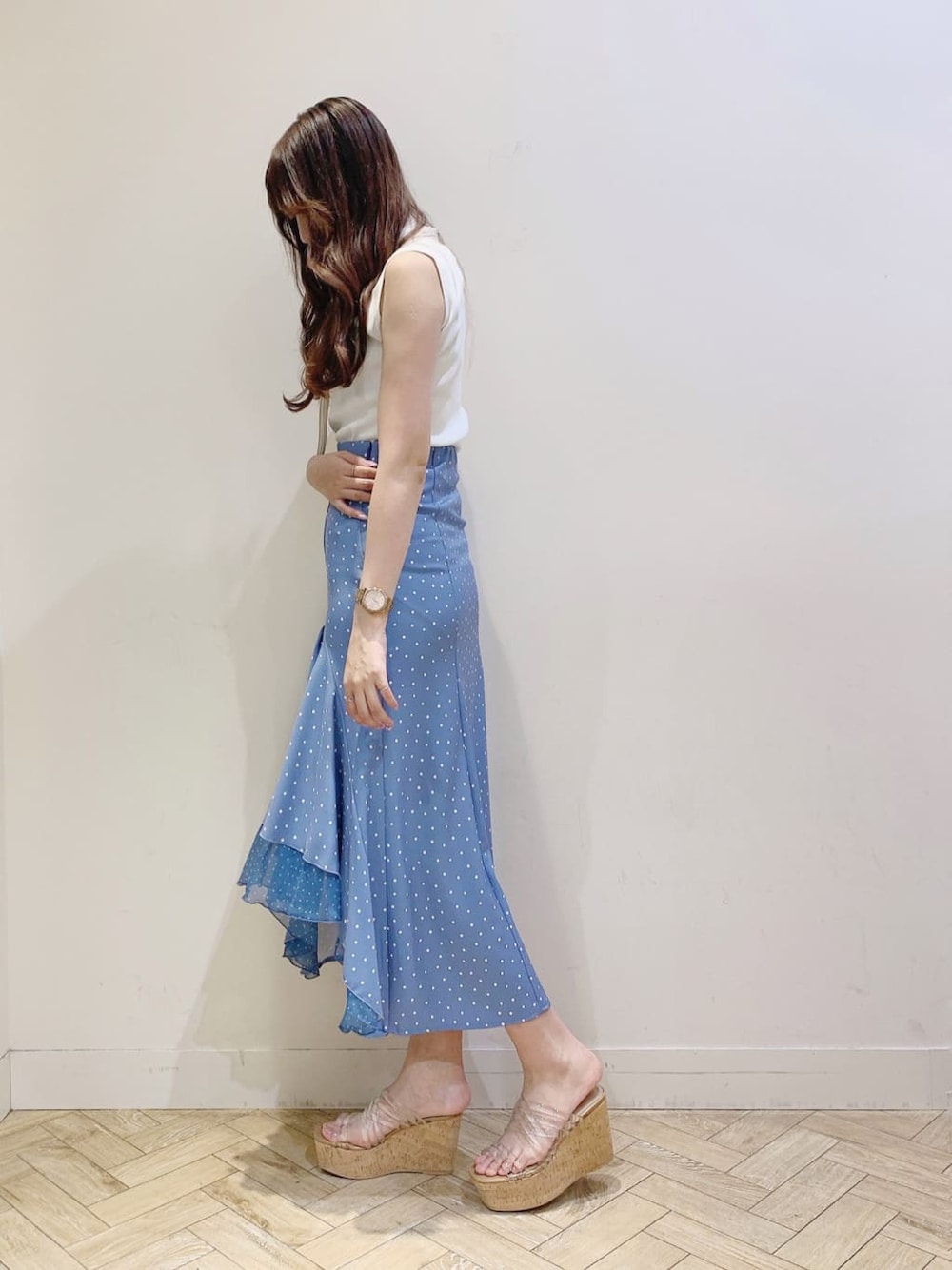 ブルー系のスカート、その他のサンダル、ホワイト系のニット/セーターを着用したレディースの春コーディネートの3枚目の写真