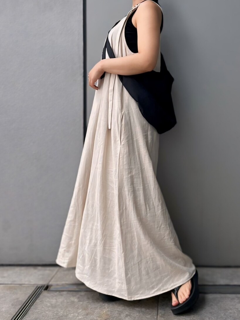 ホワイト系のワンピース、ブラック系のタンクトップ、ブラック系のショルダーバッグを着用したレディースの夏コーディネートの3枚目の写真