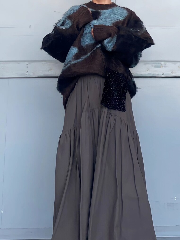 ブラウン系のニット/セーター、ブラック系のショルダーバッグ、グレー系のスカートを着用したレディースの秋コーディネートの2枚目の写真