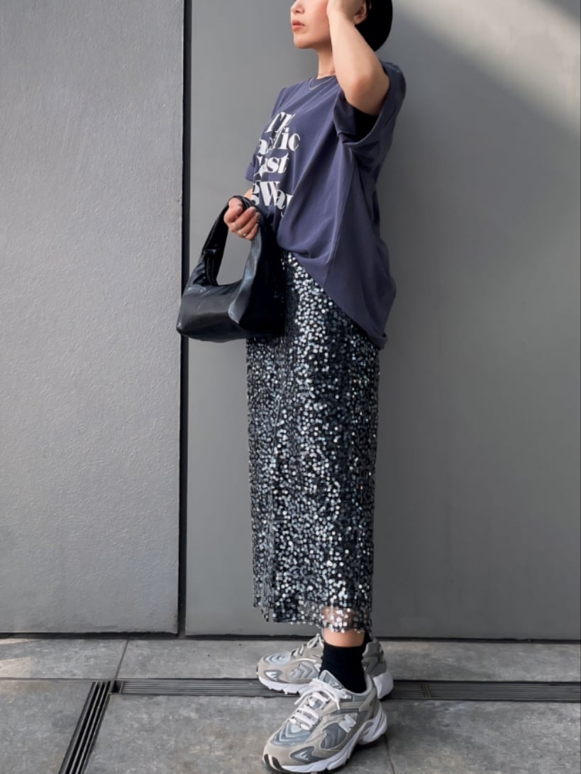 ブルー系のTシャツ/カットソー、ブラック系のスカート、ブラック系のハンドバッグを着用したレディースの春コーディネートの4枚目の写真