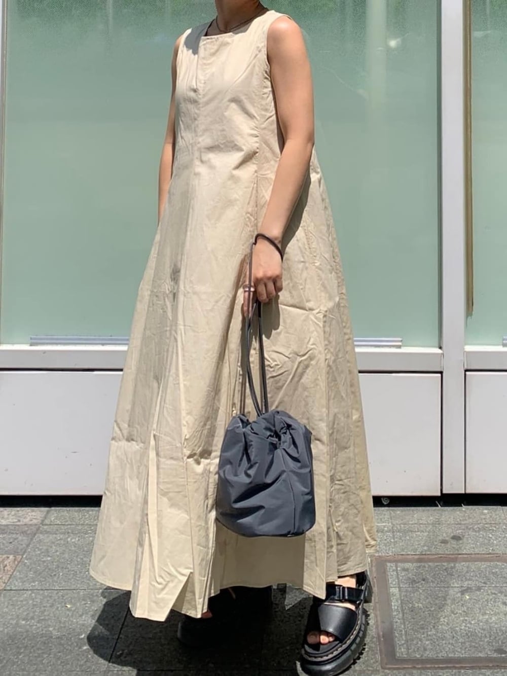 ホワイト系のシャツ/ブラウス、グレー系のハンドバッグ、ブラック系のワンピースを着用したレディースの春コーディネートの2枚目の写真