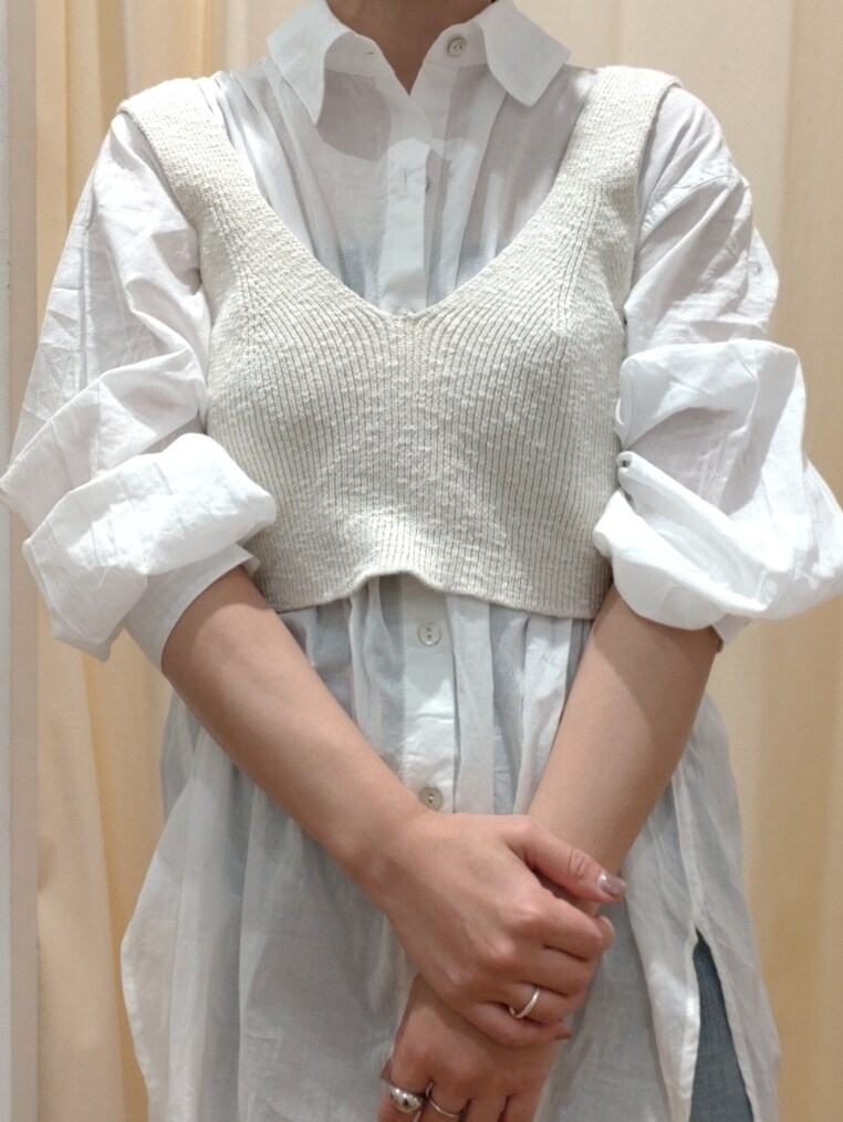 ホワイト系のベスト、ホワイト系のシャツ/ブラウス、ブラック系のハンドバッグを着用したレディースの春コーディネートの4枚目の写真