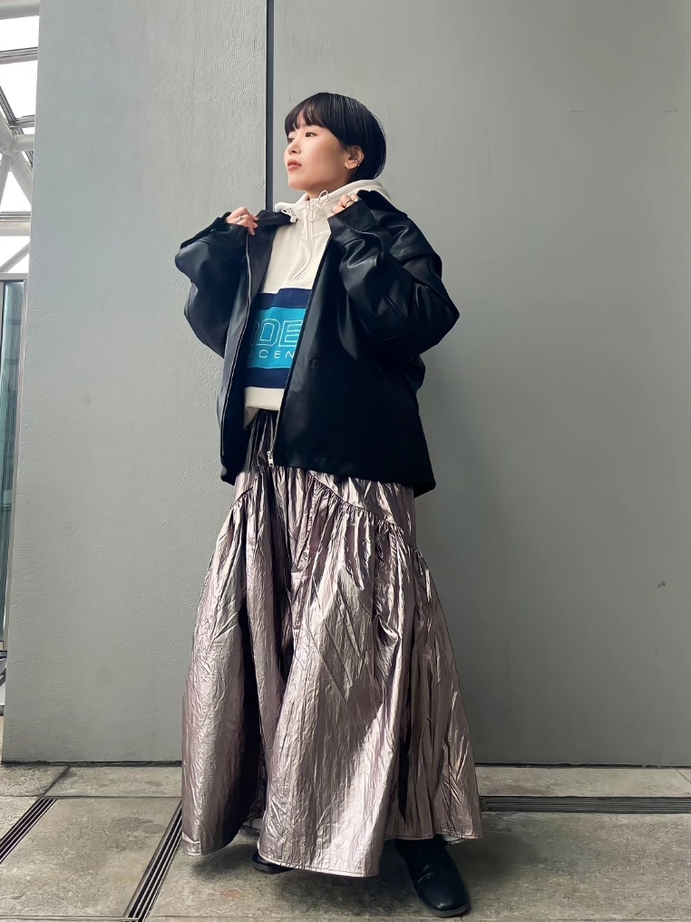 ホワイト系のパーカー、シルバー系のスカート、ブラック系のブーツを着用したレディースの冬コーディネートの3枚目の写真