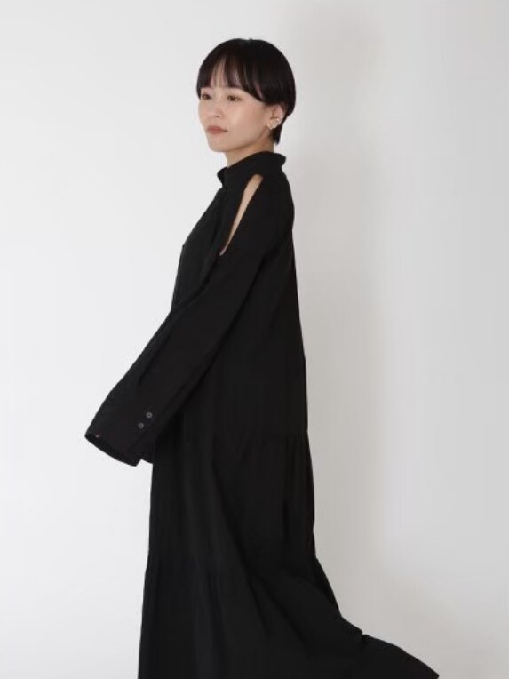 ブラック系のワンピース、ホワイト系のスニーカーを着用したレディースの春コーディネートの2枚目の写真