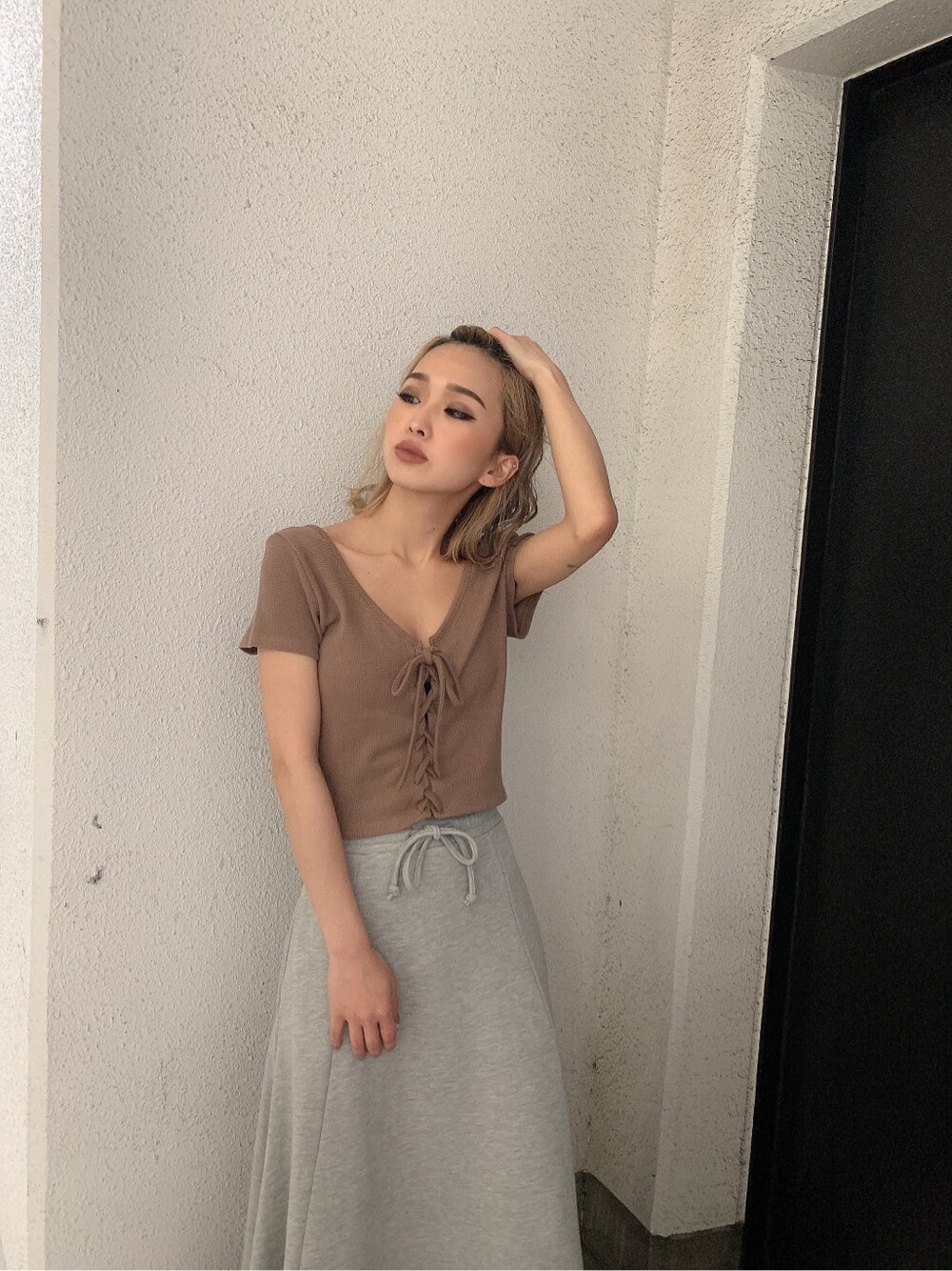 グレー系のスカート、ベージュ系のTシャツ/カットソーを着用したレディースの春コーディネートの3枚目の写真