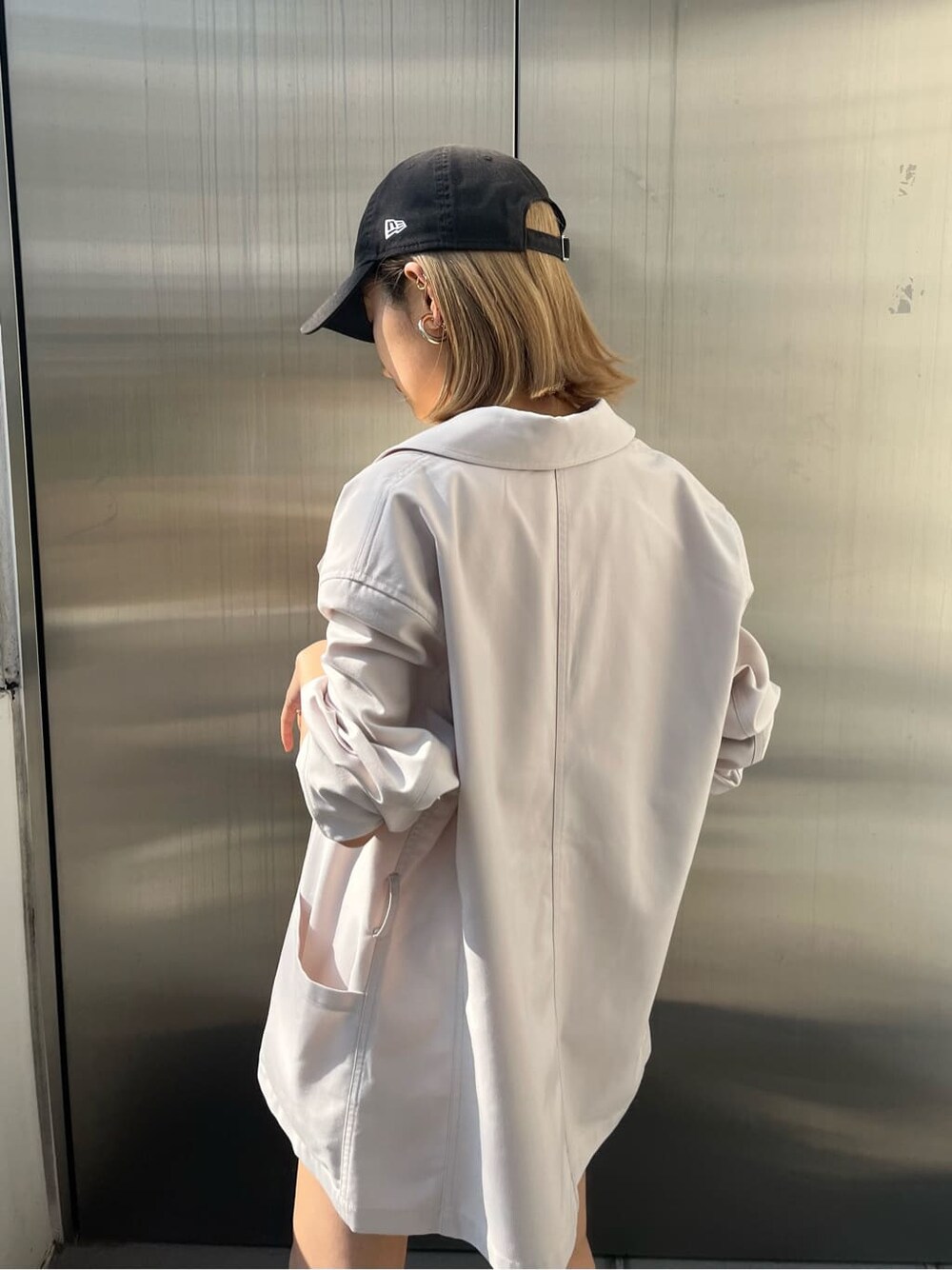 ホワイト系のテーラードジャケット、ホワイト系のスカートを着用したレディースの春コーディネートの3枚目の写真