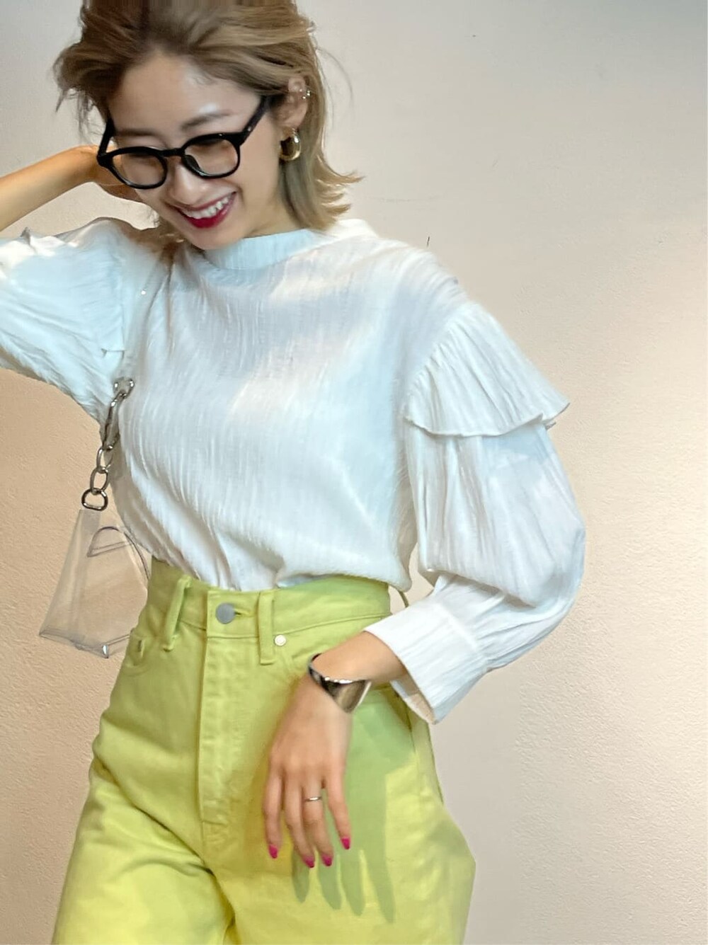 ホワイト系のキャミソール、イエロー系のデニムパンツ、ホワイト系のシャツ/ブラウスを着用したレディースの春コーディネートの5枚目の写真