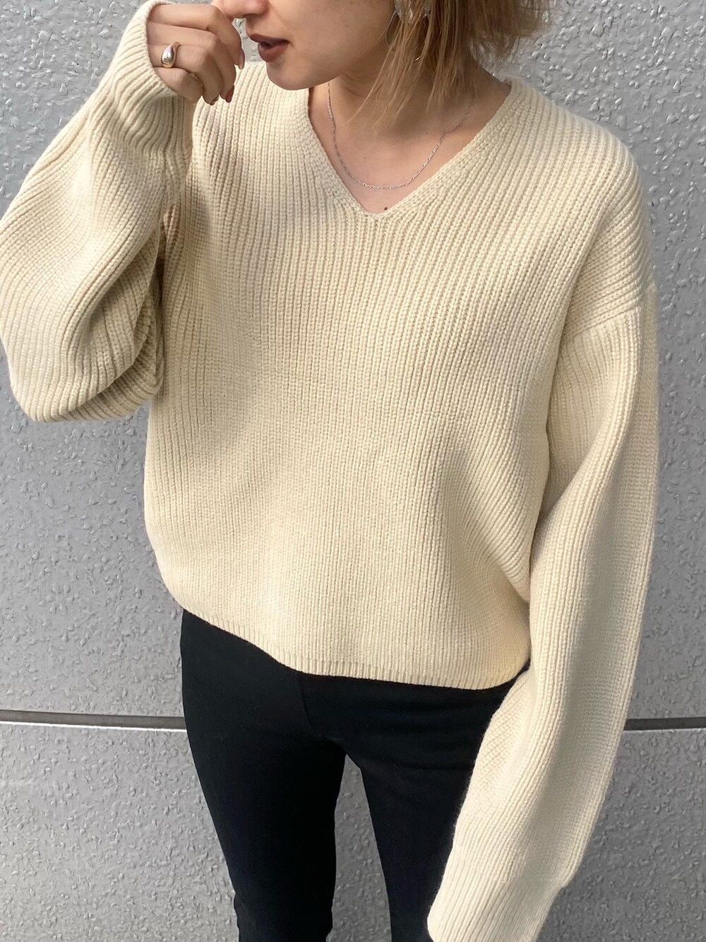 ブラック系のデニムパンツ、ホワイト系のニット/セーター、その他のローファーを着用したレディースの冬コーディネートの4枚目の写真