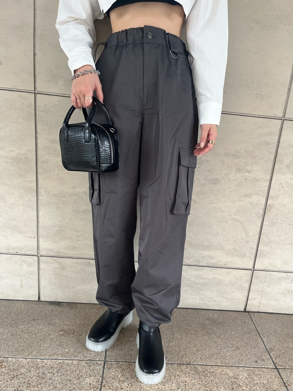 ホワイト系のシャツ/ブラウス、グレー系のカーゴパンツ、ブラック系のブーツを着用したレディースの秋コーディネートの4枚目の写真