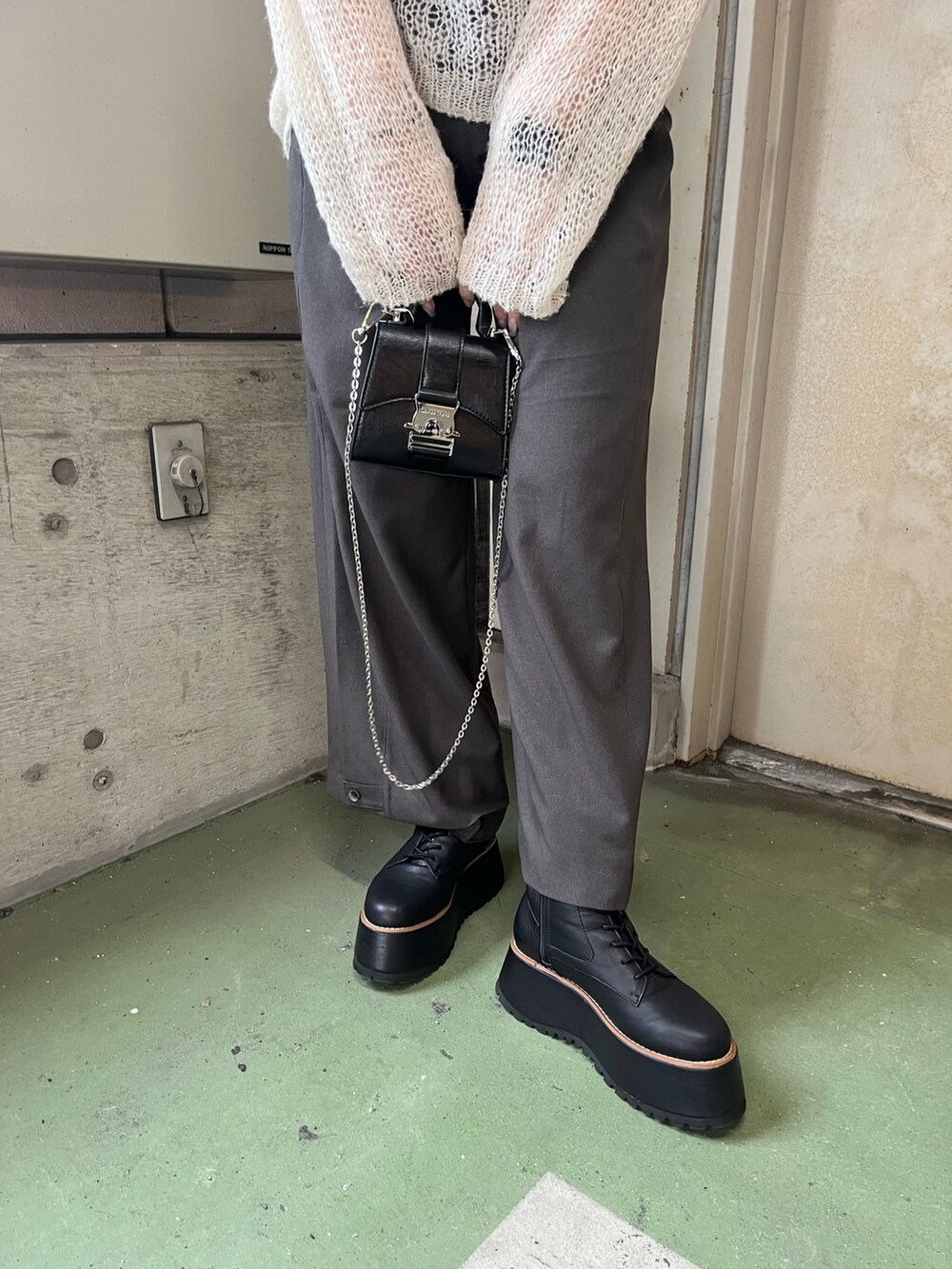 ホワイト系のニット/セーター、グレー系のその他パンツ、ブラック系のブーツを着用したレディースの秋コーディネートの6枚目の写真