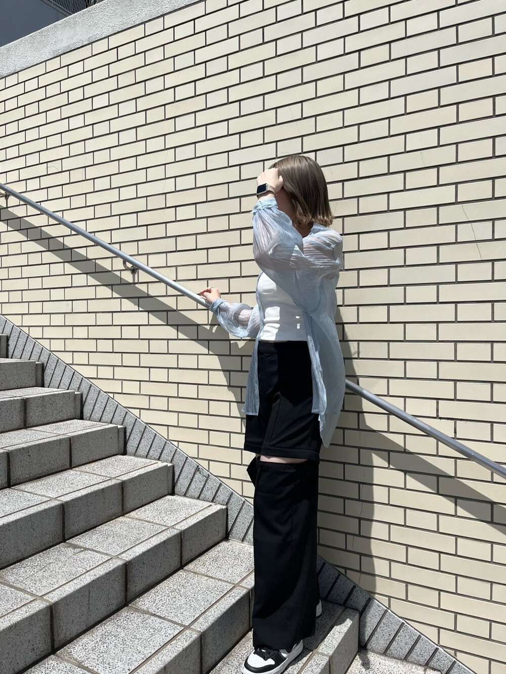 ブルー系のシャツ/ブラウス、ブラック系のスラックス、ホワイト系のTシャツ/カットソーを着用したレディースの春コーディネートの4枚目の写真