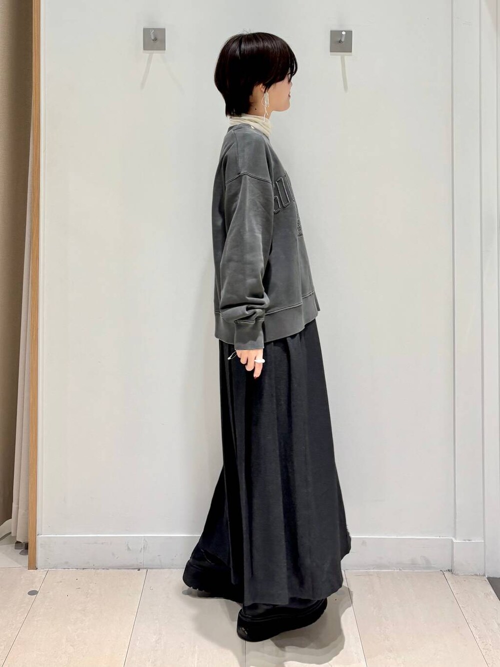 ホワイト系のTシャツ/カットソー、グレー系のスカート、グレー系のスウェットを着用したレディースの秋コーディネートの5枚目の写真