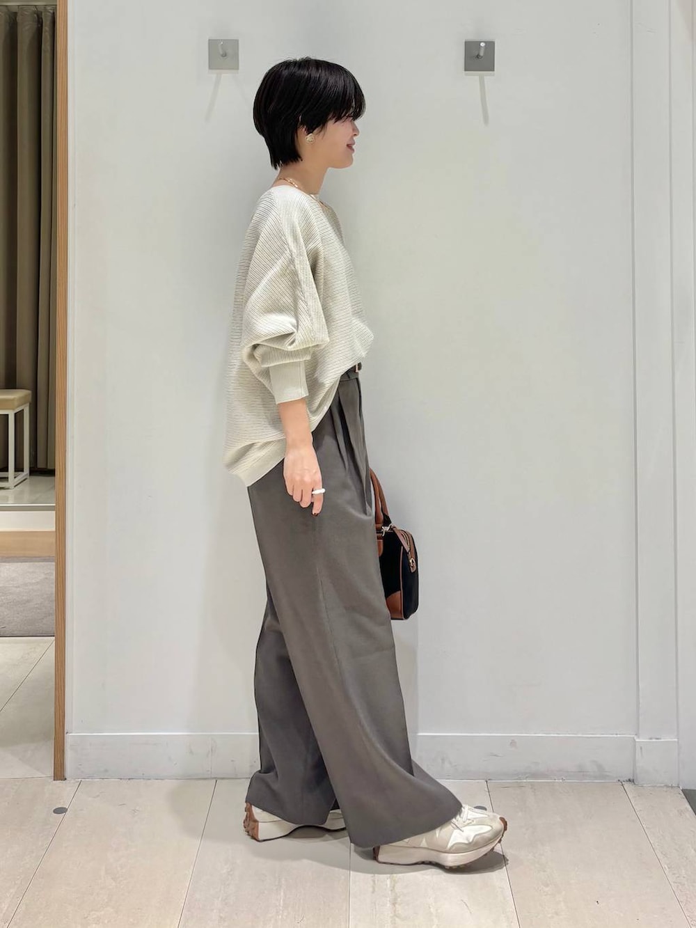 ブラウン系のその他パンツ、グレー系のニット/セーター、ブラック系のボストンバッグを着用したレディースの秋コーディネートの4枚目の写真