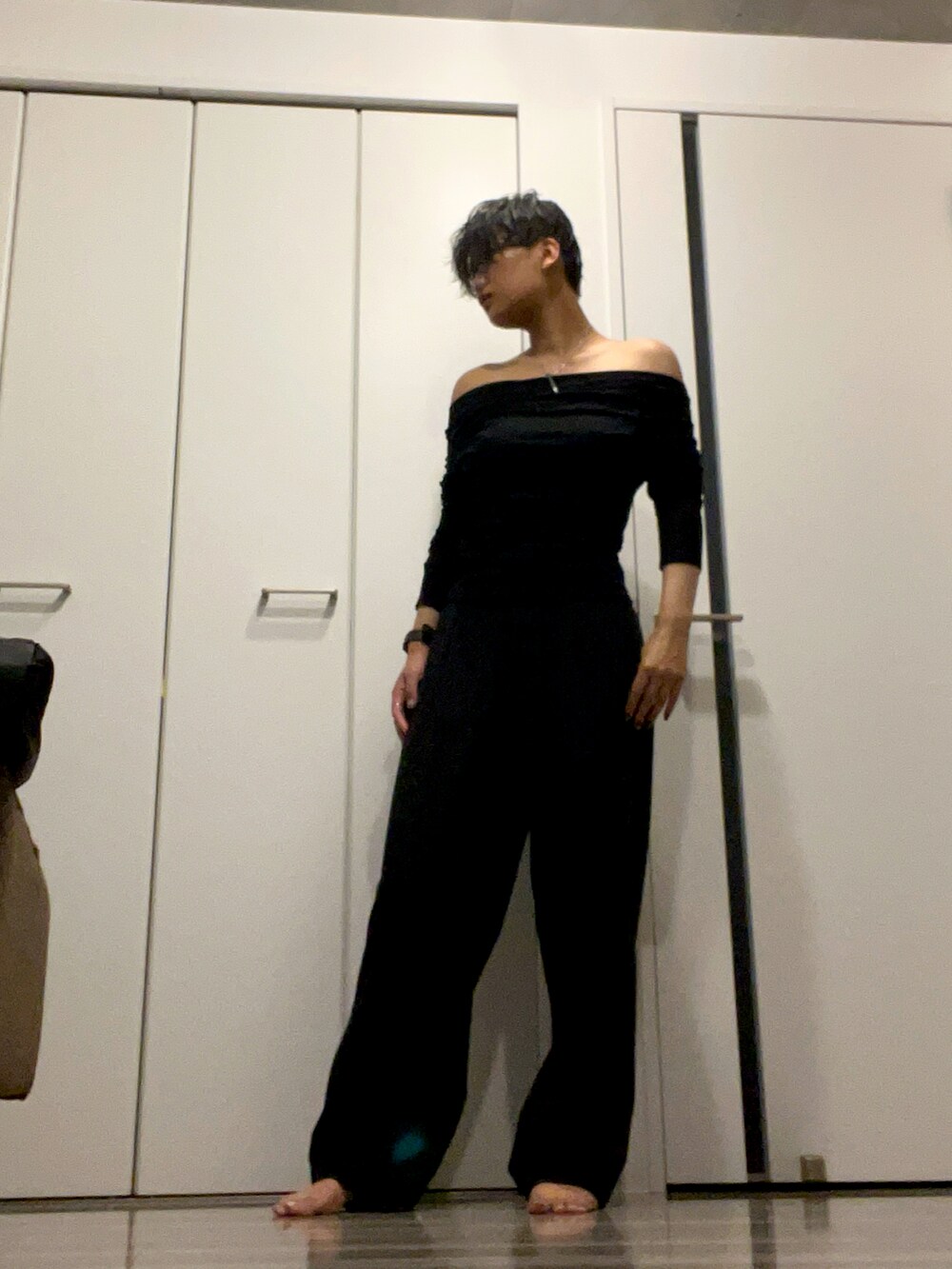 ブラック系のバッグ、グレー系のスラックス、ブラック系のTシャツ/カットソーを着用したレディースの夏コーディネートの2枚目の写真