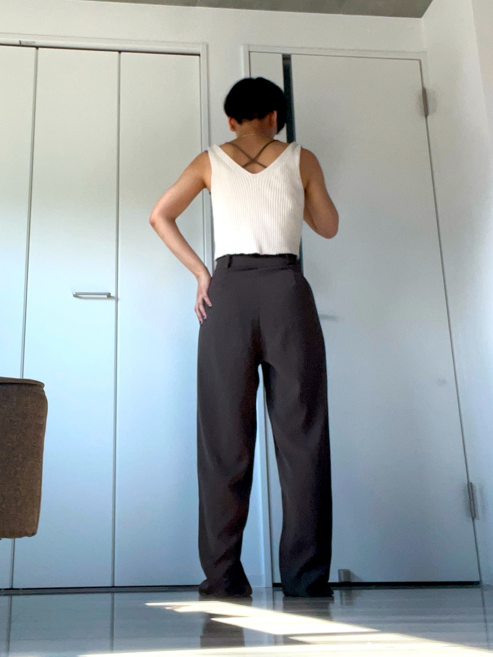 ブラウン系のスラックス、ベージュ系のショルダーバッグを着用したレディースの夏コーディネートの2枚目の写真