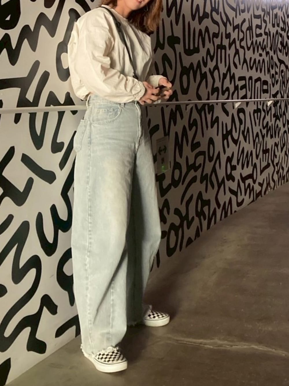 ブルー系のデニムパンツ、その他のスリッポン、ホワイト系のTシャツ/カットソーを着用したレディースの春コーディネートの2枚目の写真