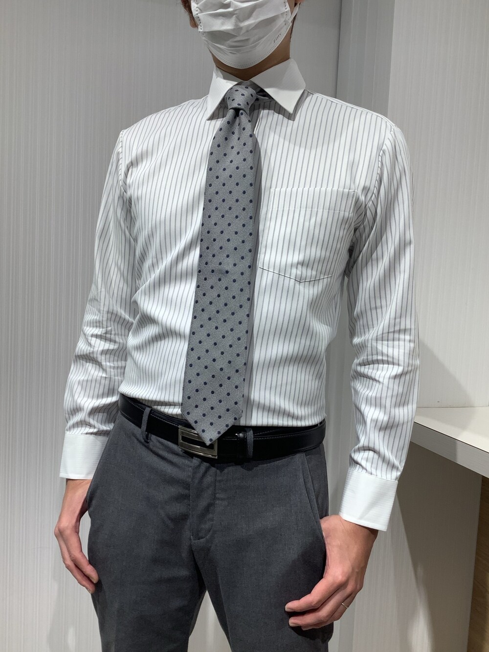 グレー系のビジネスシャツ、その他のネクタイを着用したメンズの冬コーディネートの2枚目の写真