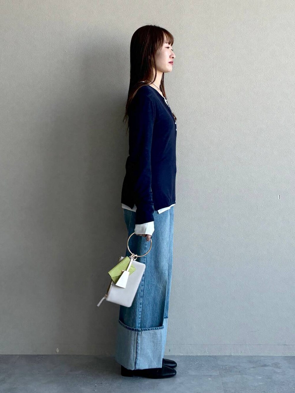 ブラック系のローファー、グレー系のショルダーバッグ、ブルー系のデニムパンツを着用したレディースの冬コーディネートの4枚目の写真