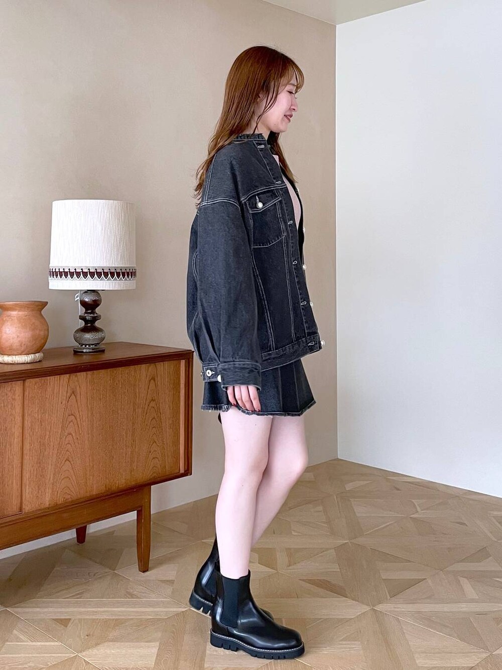 ピンク系のニット/セーター、ブラック系のブーツ、ブラック系のショルダーバッグを着用したレディースの冬コーディネートの2枚目の写真