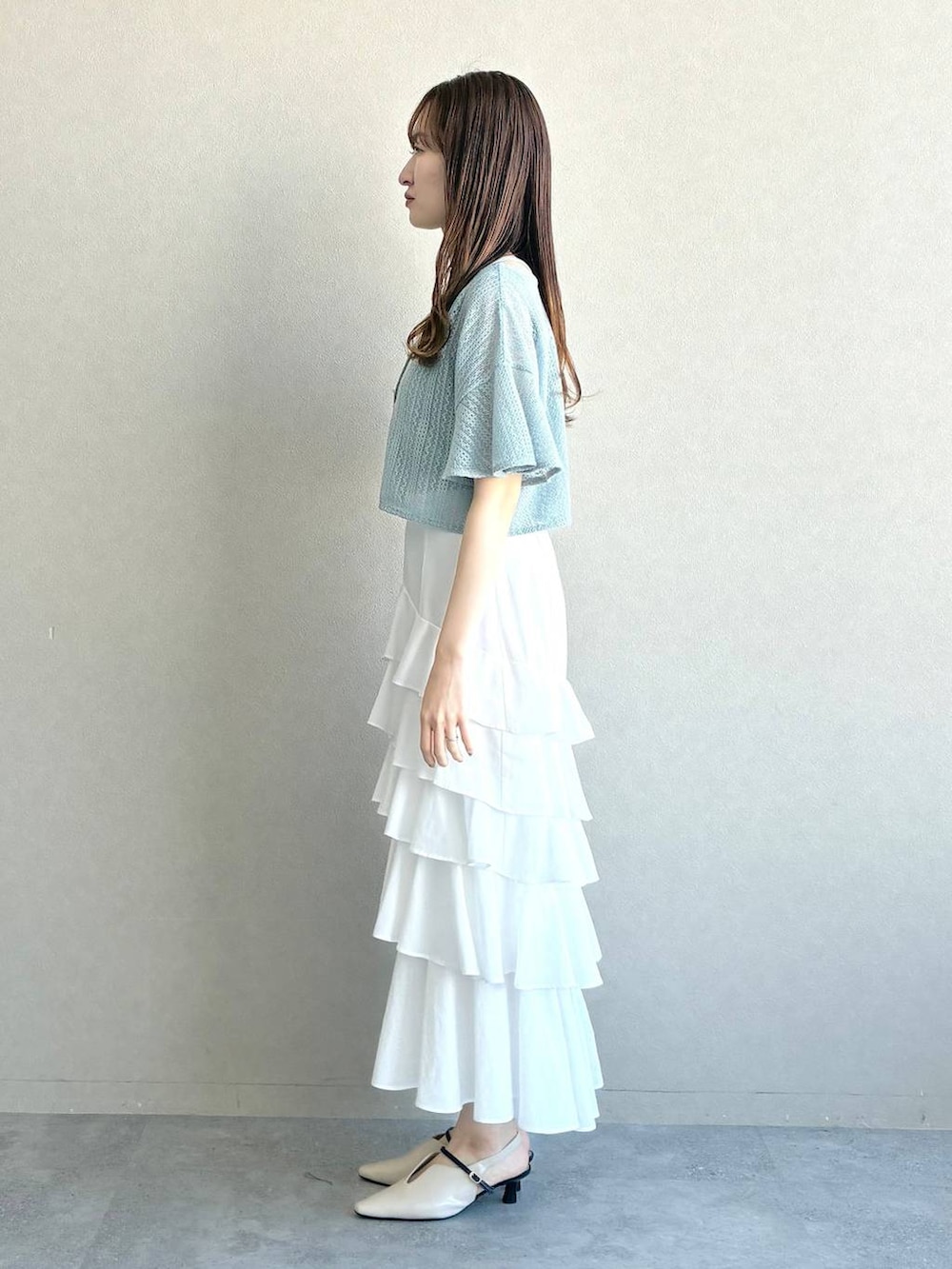 ブルー系のカーディガン/ボレロ、ホワイト系のサンダル、グレー系のショルダーバッグを着用したレディースの春コーディネートの2枚目の写真