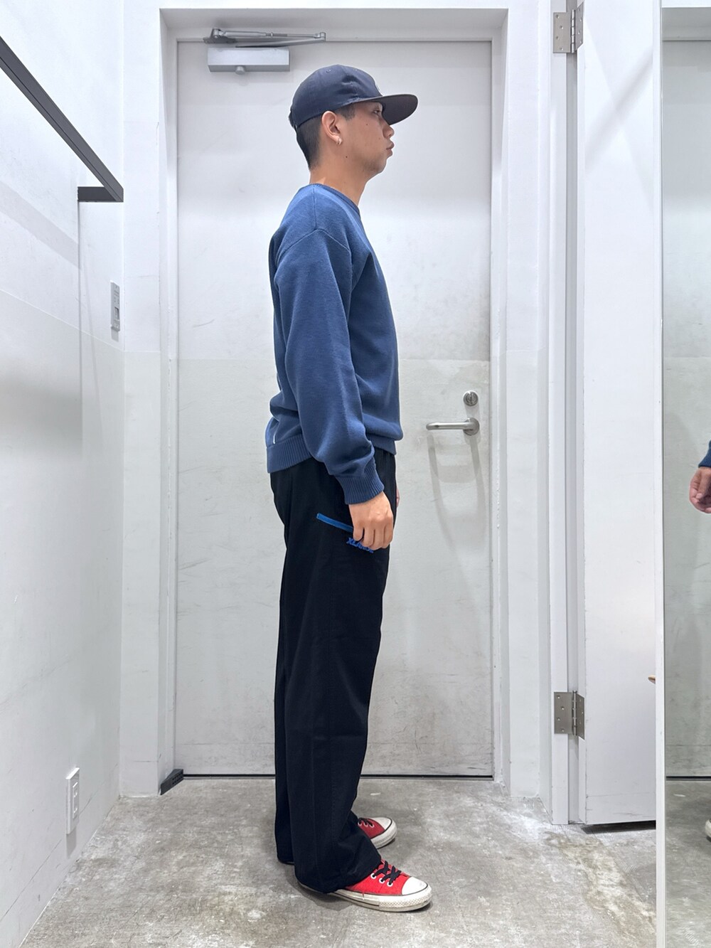 ブルー系のニット/セーター、ブラック系のその他パンツ、ブルー系のキャップを着用したメンズの秋コーディネートの4枚目の写真