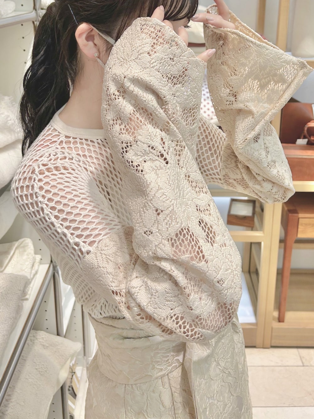 ベージュ系のスカート、ベージュ系のトップス、ベージュ系のブーツを着用したレディースの夏コーディネートの3枚目の写真