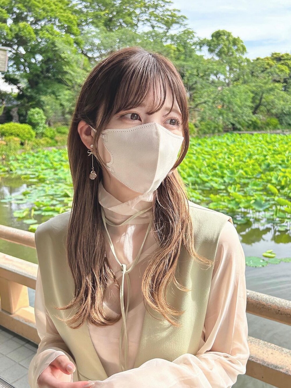 グリーン系のジャンパースカート、ベージュ系のシャツ/ブラウス、ベージュ系のブーツを着用したレディースの春コーディネートの3枚目の写真